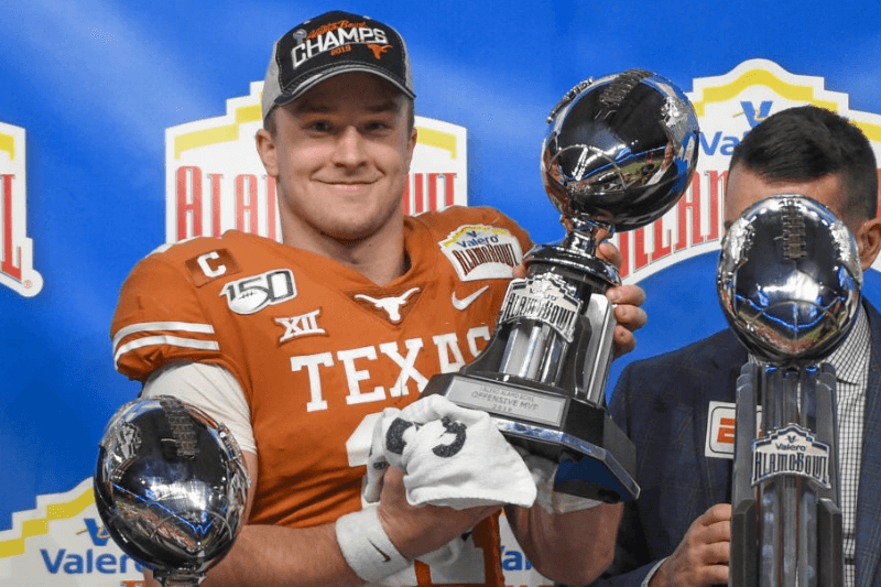 Texas Longhorns quarterback Sam Ehlinger (11) accepts the trophy for Offensive Player of the Game following the Alamo Bowl football game between the Utah Utes and Texas Longhorns at the Alamodome on December 31, 2019 in San Antonio, TX.