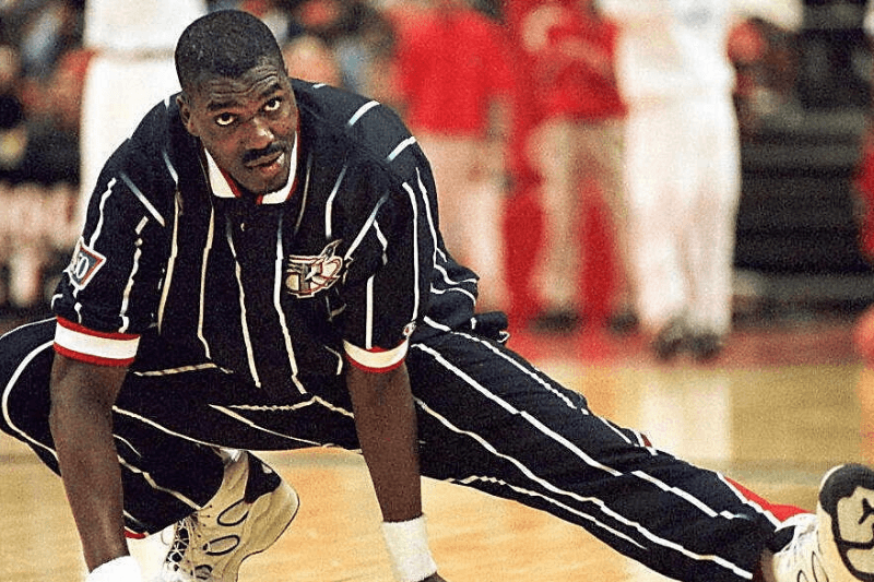 LANDOVER, MD - DECEMBER 1: Houston Rockets center Hakeem Olajuwon stretches out before Houston's game against the Washington Bullets in Landover, Maryland 30 November. For the second time in two weeks, Olajuwon has been hospitalized with an irregular heartbeat. Olajuwon checked into a Houston hospital early 01 December where his condition was listed as "very good."