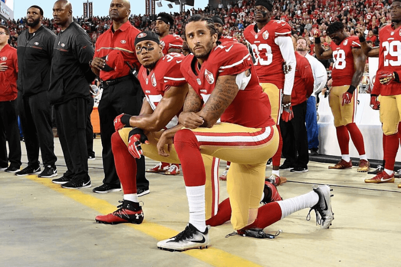 SANTA CLARA, CA - SEPTEMBER 12: Colin Kaepernick #7 and Eric Reid #35 of the San Francisco 49ers kneel in protest during the national anthem prior to playing the Los Angeles Rams in their NFL game at Levi's Stadium on September 12, 2016 in Santa Clara, California.