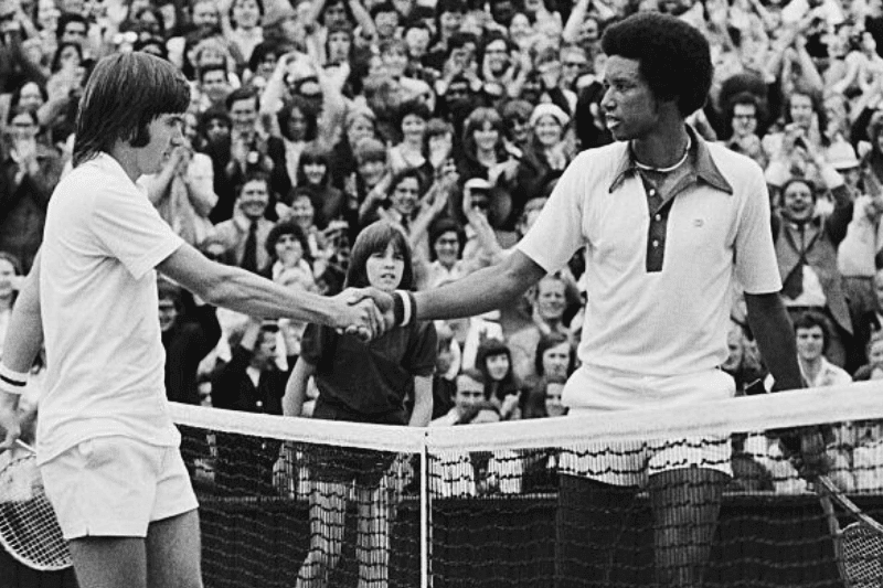 Wimbledon:Artur Ashe, USA and Jimmy Connors, USA shake hands over the net here 7/5, after Ashe had won the men's singles title, with score 6-1,6-1,5-7,6-4, 5th July 1975.