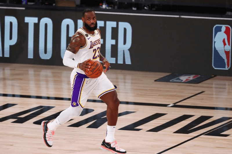 Aug 3, 2020; Lake Buena Vista, Florida, USA; Los Angeles Lakers forward LeBron James (23) brings the ball up court against the Utah Jazz during the first half of a NBA game at The Arena at the ESPN Wide World of Sports Complex.