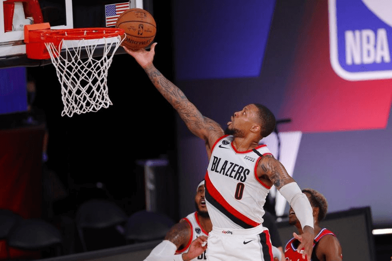 Aug 9, 2020; Lake Buena Vista, Florida, USA; Damian Lillard #0 of the Portland Trail Blazers goes up for a shot against the Philadelphia 76ers during the second quarter at Visa Athletic Center at ESPN Wide World Of Sports Complex on August 09, 2020 in Lake Buena Vista, Florida