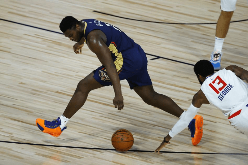 Aug 1, 2020; Lake Buena Vista, USA; Zion Williamson #1 of the New Orleans Pelicans looses the ball against Paul George #13 of the LA Clippers at HP Field House at ESPN Wide World Of Sports Complex on August 01, 2020 in Lake Buena Vista, Florida. 