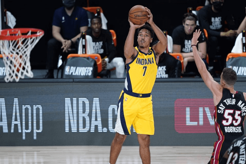 Aug 18, 2020; Lake Buena Vista, Florida, USA; Indiana Pacers guard Malcolm Brogdon (7) shoots past Miami Heat guard Duncan Robinson (55) during the first half of an NBA basketball first round playoff game, Tuesday, Aug. 18, 2020, in Lake Buena Vista, Fla