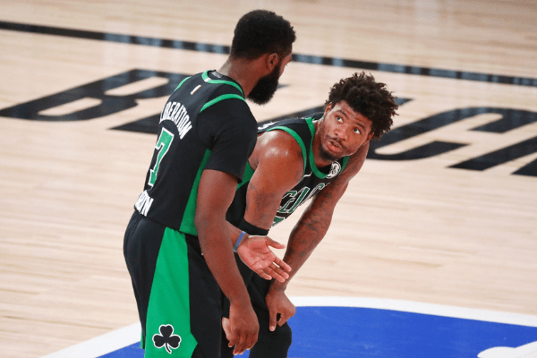 Sep 17, 2020; Lake Buena Vista, Florida, USA; Boston Celtics guard Jaylen Brown (left) talks with guard Marcus Smart (36) ring the fourth quarter in game two of the Eastern Conference Finals of the 2020 NBA Playoffs against the Miami Heat at ESPN Wide World of Sports Complex. The Miami Heat won 106-101. Mandatory Credit: Kim Klement-USA TODAY Sports