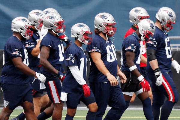 FOXBOROUGH, MASSACHUSETTS - AUGUST 28: New England Patriots players walk on the field during training camp at Gillette Stadium on August 28, 2020 in Foxborough, Massachusetts.