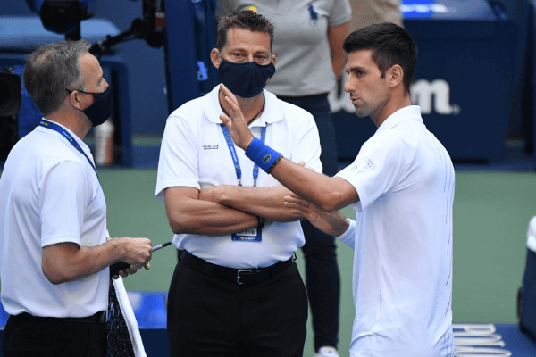Sep 6, 2020; Flushing Meadows, New York, USA; Novak Djokovic of Serbia discusses with a tournament official after being defaulted for striking a lines person with a ball against Pablo Carreno Busta of Spain (not pictured) on day seven of the 2020 U.S. Open tennis tournament at USTA Billie Jean King National Tennis Center.