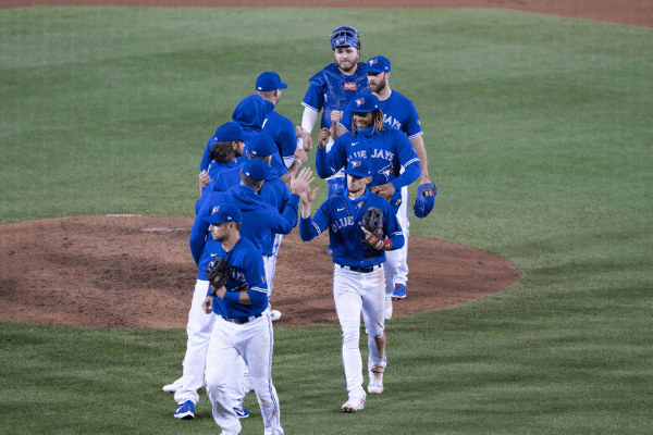 Sep 26, 2020; Buffalo, New York, USA; Toronto Blue Jays third baseman Cavan Biggio (8) and designated hitter Vladimir Guerrero Jr. (27) and pitcher Anthony Bass (52) and designated hitter Alejandro Kirk (85) celebrate with teammates after defeating the Baltimore Orioles at Sahlen Field.