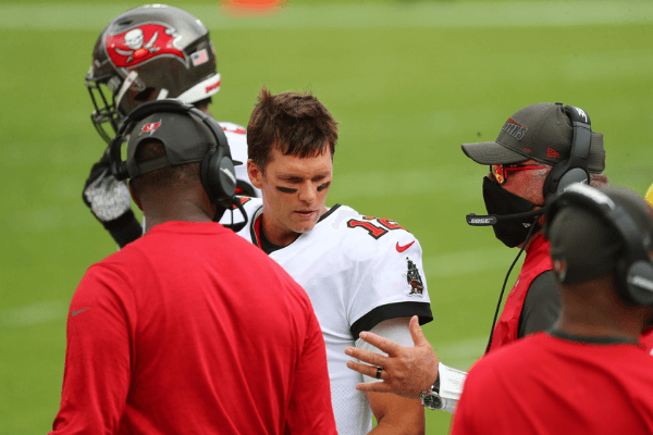 Sep 20, 2020; Tampa, Florida, USA; Tampa Bay Buccaneers quarterback Tom Brady (12) talks with head coach Bruce Arians (right) and offensive coordinator Byron Leftwich against the Carolina Panthers during the second quarter at Raymond James Stadium.