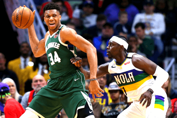 Giannis Antetokounmpo #34 of the Milwaukee Bucks drives against Jrue Holiday #11 of the New Orleans Pelicans during the second half at the Smoothie King Center on February 04, 2020 in New Orleans, Louisiana.