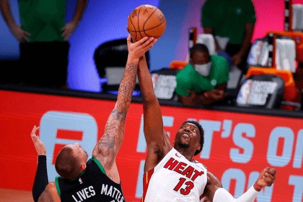 Bam Adebayo #13 of the Miami Heat and Daniel Theis #27 of the Boston Celtics compete for a jump ball during the fourth quarter in Game Two of the Eastern Conference Finals during the 2020 NBA Playoffs at AdventHealth Arena at the ESPN Wide World Of Sports Complex on September 17, 2020 in Lake Buena Vista, Florida