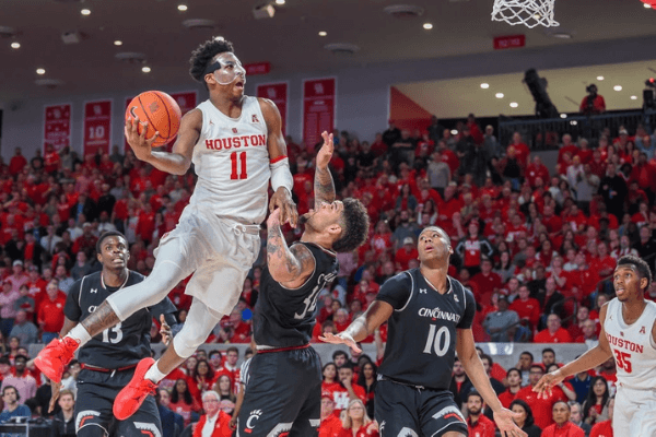 Houston Cougars guard Nate Hinton (11) towers over Cincinnati Bearcats guard Jarron Cumberland (34) as he attempts a second half finger roll during the basketball game between the Cincinnati Bearcats and Houston Cougars on February 10, 2019 at the Fertitta Center in Houston, Texas. 