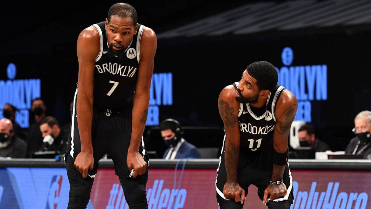 Kevin Durant and Kyrie Irving of the Brooklyn Nets look at each other