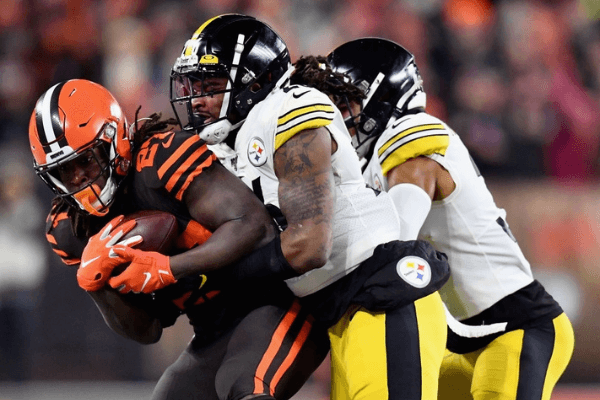 Running back Kareem Hunt #27 of the Cleveland Browns is tackled by the defense of the Pittsburgh Steelers during the game at FirstEnergy Stadium on November 14, 2019 in Cleveland, Ohio. 