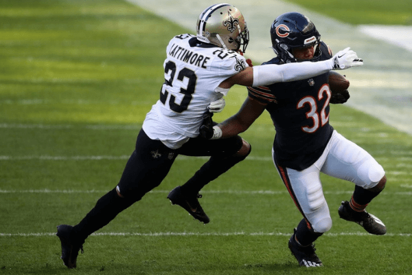 David Montgomery #32 of the Chicago Bears runs the ball against Marshon Lattimore #23 of the New Orleans Saints in the first quarter at Soldier Field on November 01, 2020 in Chicago, Illinois.