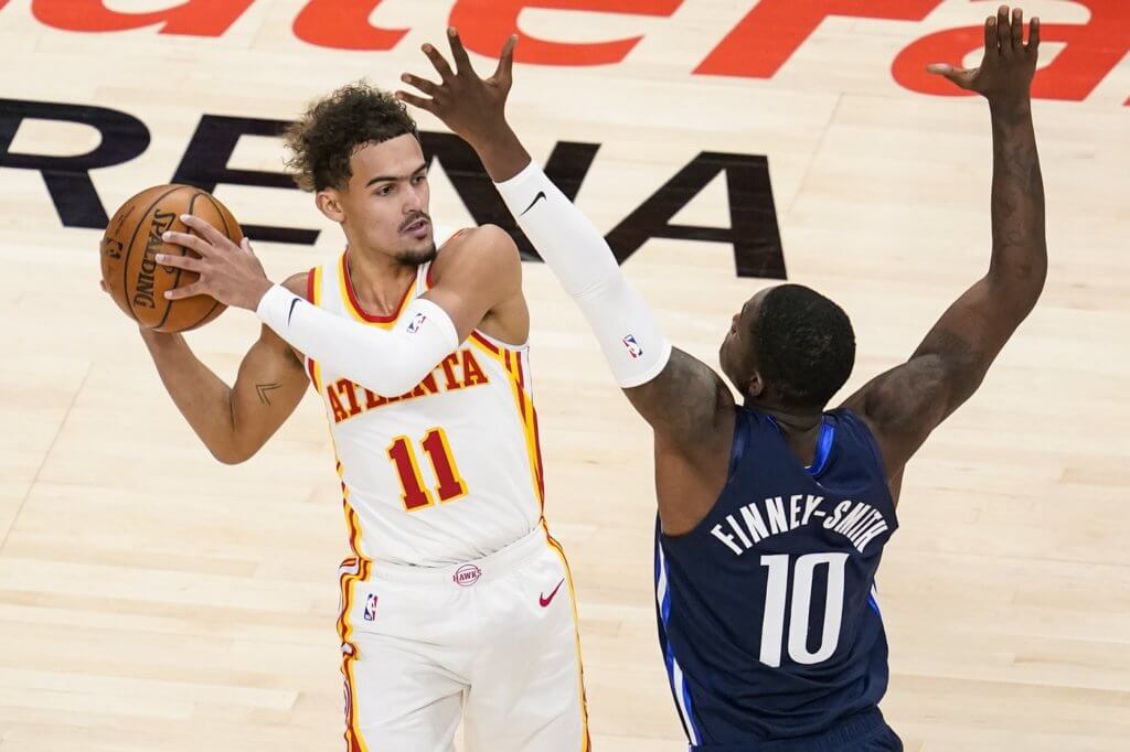 Atlanta Hawks guard Trae Young (11) looks for a pass against Dallas Mavericks forward Dorian Finney-Smith (10) during the second half at State Farm Arena. 