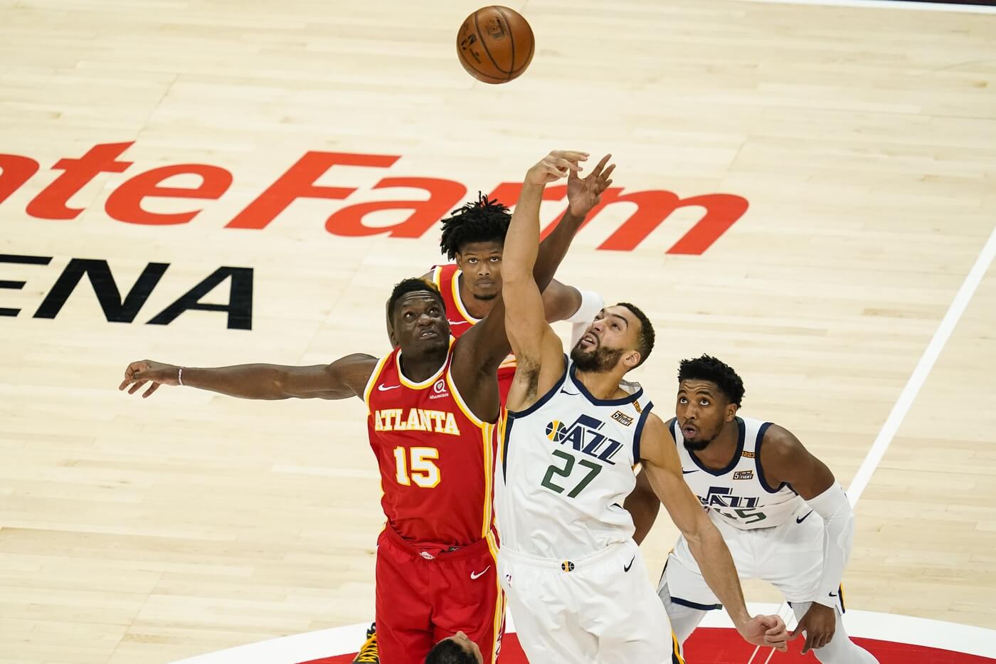 Atlanta Hawks center Clint Capela (15) and Utah Jazz center Rudy Gobert (27) battle for the opening tip during the first quarter at State Farm Arena.