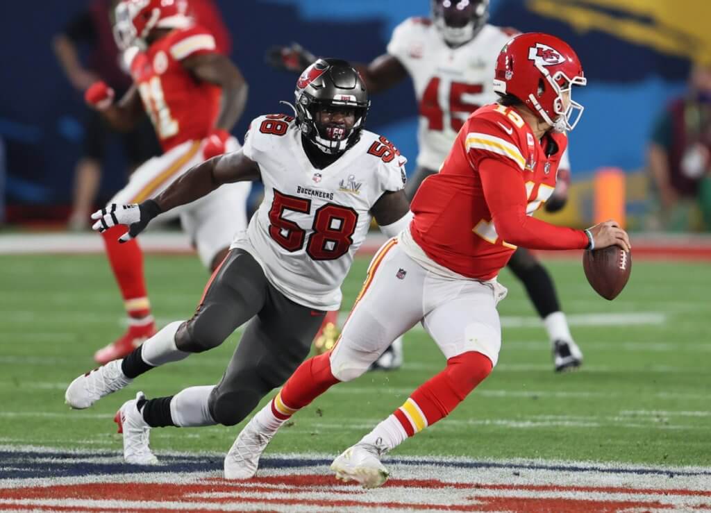 Kansas City Chiefs quarterback Patrick Mahomes (15) is chased by Tampa Bay Buccaneers outside linebacker Shaquil Barrett (58) in the second half during Super Bowl LV at Raymond James Stadium.