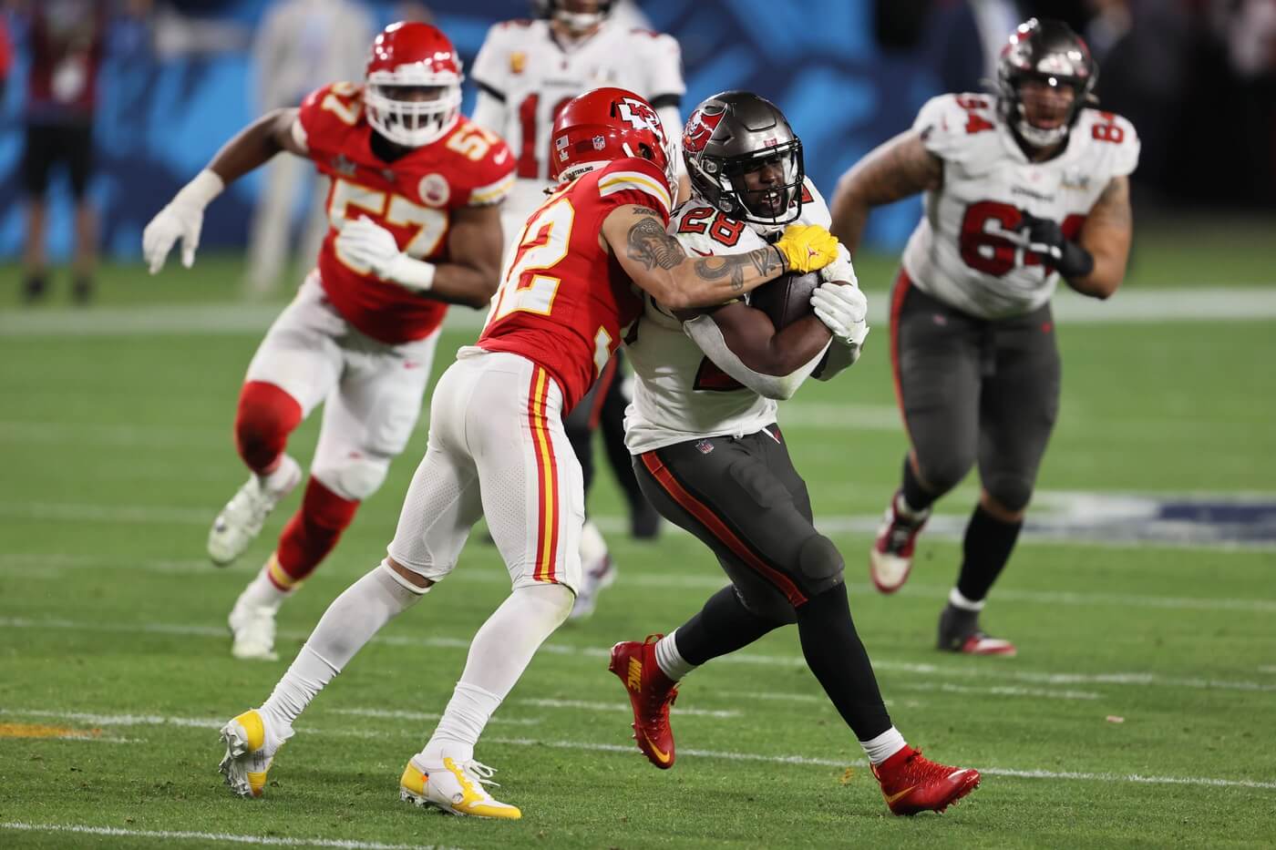 Tampa Bay Buccaneers running back Leonard Fournette (28) is tackled by Kansas City Chiefs strong safety Tyrann Mathieu (32) in the second half during Super Bowl LV at Raymond James Stadium.