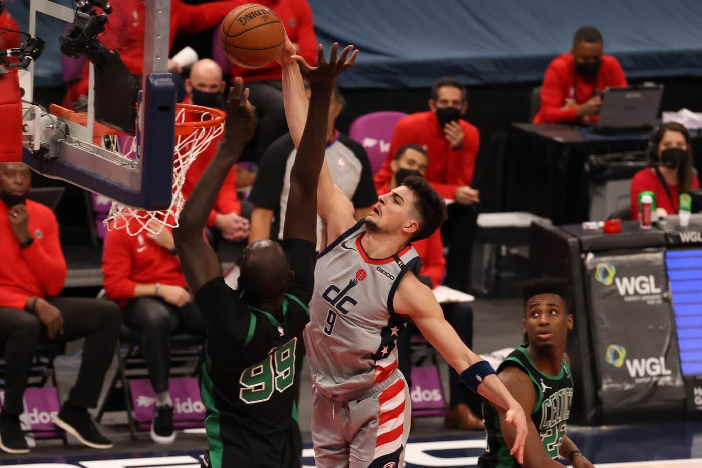 Feb 14, 2021; Washington, District of Columbia, USA; Washington Wizards forward Deni Avdija (9) is fouled while attempting to dunk the ball by Boston Celtics center Tacko Fall (99) in the fourth quarter at Capital One Arena. Mandatory Credit: Geoff Burke-USA TODAY Sports