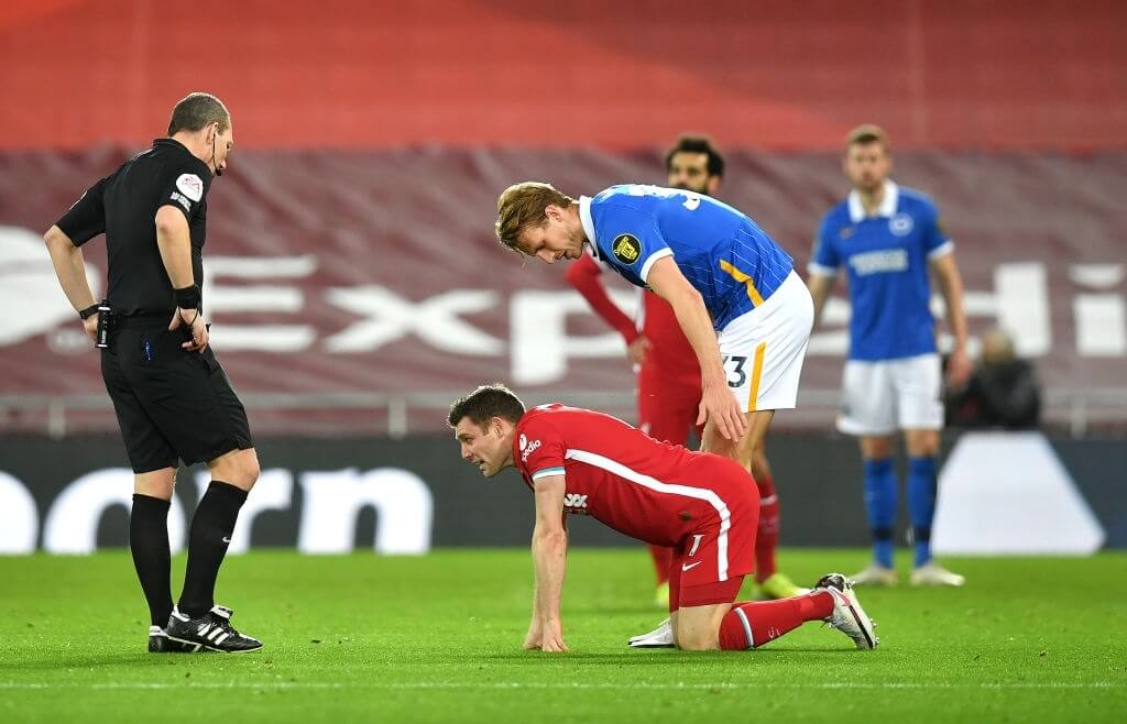 LIVERPOOL, ENGLAND - FEBRUARY 03: James Milner of Liverpool lies injured during the Premier League match between Liverpool and Brighton & Hove Albion at Anfield on February 03, 2021 in Liverpool, England. Sporting stadiums around the UK remain under strict restrictions due to the Coronavirus Pandemic as Government social distancing laws prohibit fans inside venues resulting in games being played behind closed doors. (Photo by Paul Ellis - Pool/Getty Images)