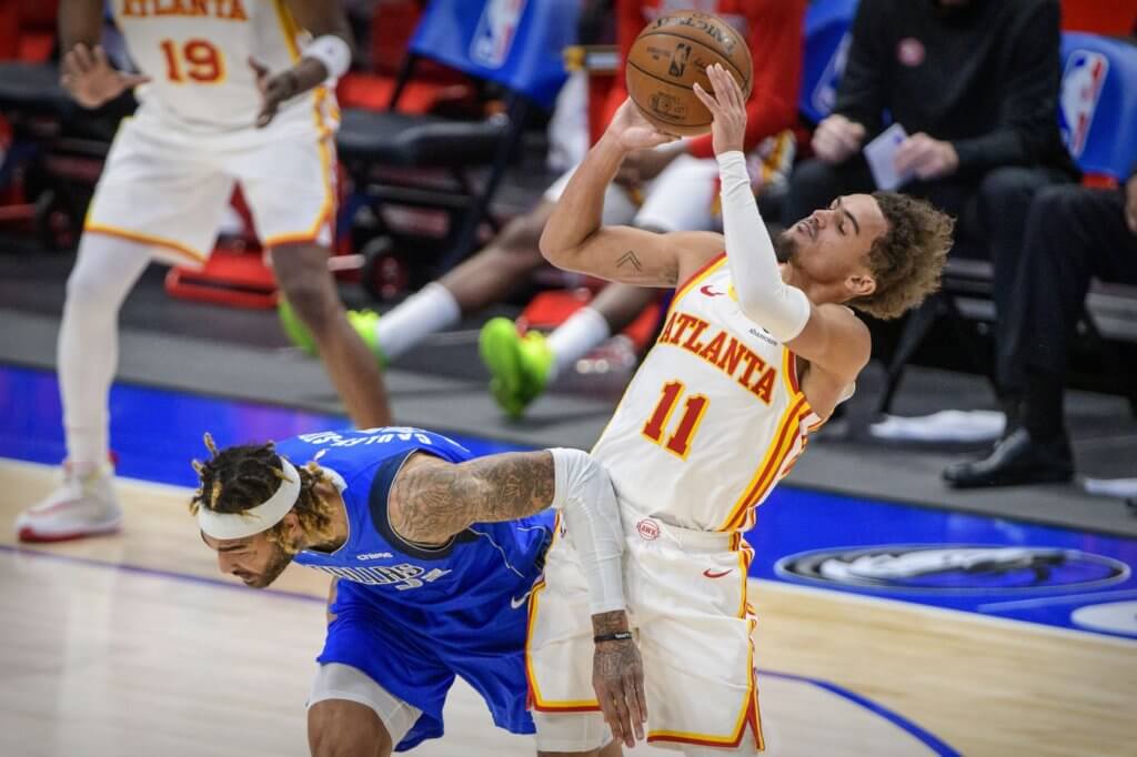 Feb 10, 2021; Dallas, Texas, USA; Atlanta Hawks guard Trae Young (11) is fouled by Dallas Mavericks center Willie Cauley-Stein (33) during the second half at the American Airlines Center. Mandatory Credit: Jerome Miron-USA TODAY Sports