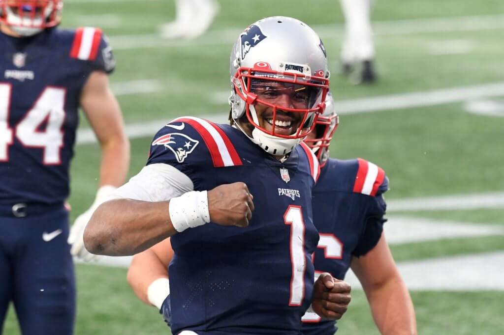 Jan 3, 2021; Foxborough, Massachusetts, USA; New England Patriots quarterback Cam Newton (1) celebrates after scoring a touchdown against the New York Jets during the third quarter at Gillette Stadium. Mandatory Credit: Brian Fluharty-USA TODAY Sports