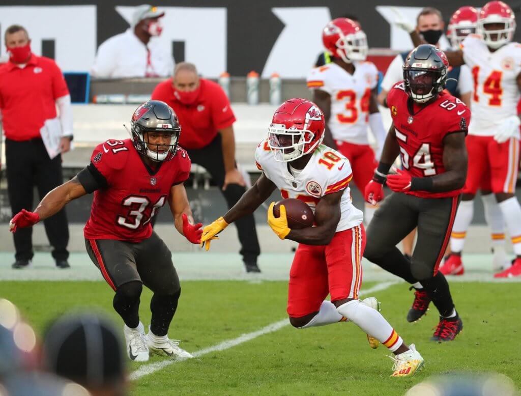 Nov 29, 2020; Tampa, Florida, USA; Kansas City Chiefs wide receiver Tyreek Hill (10) runs the ball against Tampa Bay Buccaneers strong safety Antoine Winfield Jr. (31) and inside linebacker Lavonte David (54) during the first half at Raymond James Stadium. Mandatory Credit: Kim Klement-USA TODAY Sports