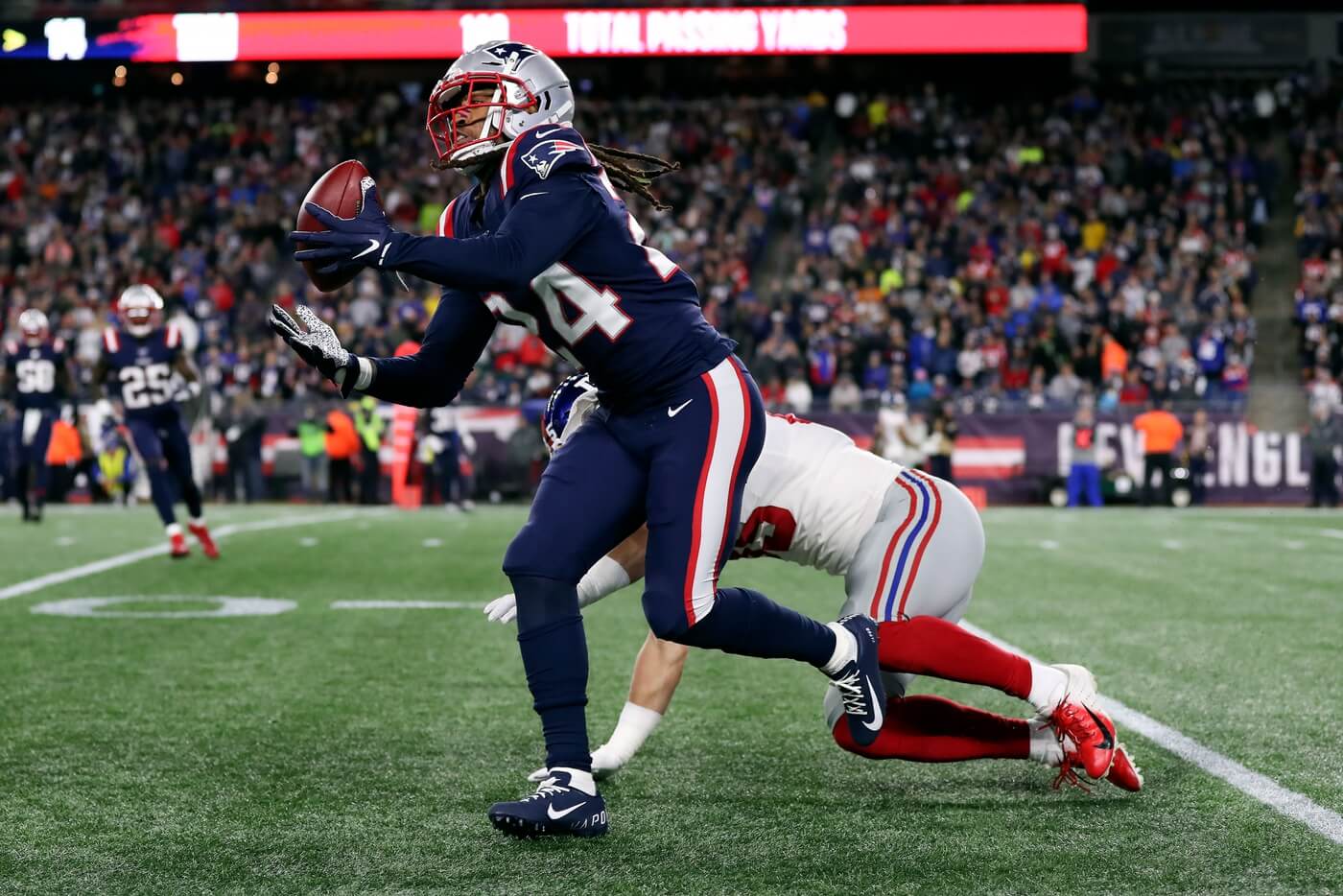 New England Patriots cornerback Stephon Gilmore (24) makes a catch in front of New York Giants tight end Garrett Dickerson (89) during the second half at Gillette Stadium.