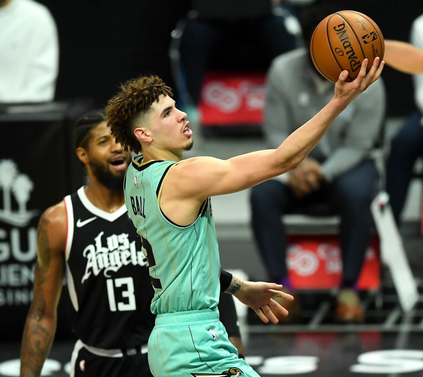 Mar 20, 2021; Los Angeles, California, USA; Los Angeles Clippers guard Paul George (13) looks on as Charlotte Hornets guard LaMelo Ball (2) goes up for a basket in the first half of the game at Staples Center. Mandatory Credit: Jayne Kamin-Oncea-USA TODAY Sports