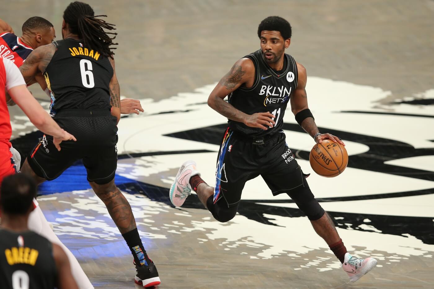 Mar 21, 2021; Brooklyn, New York, USA; Brooklyn Nets point guard Kyrie Irving (11) controls the ball against the Washington Wizards during the first quarter at Barclays Center.