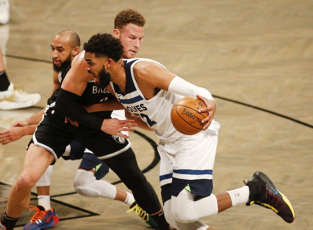 Mar 29, 2021; Brooklyn, New York, USA; Minnesota Timberwolves center Karl-Anthony Towns (32) dribbles the ball against Brooklyn Nets forward Blake Griffin (2) during the second half at Barclays Center. Mandatory Credit: Andy Marlin-USA TODAY Sports