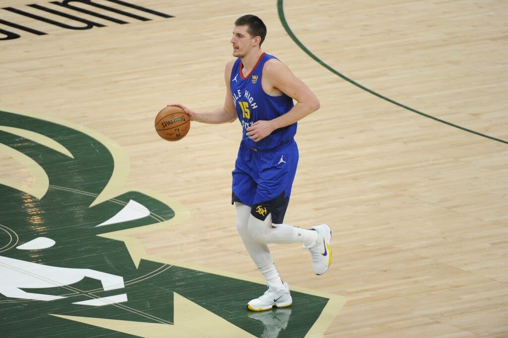 Mar 2, 2021; Milwaukee, Wisconsin, USA; Denver Nuggets center Nikola Jokic (15) brings the ball up the court against the Milwaukee Bucks at Fiserv Forum. Mandatory Credit: Michael McLoone-USA TODAY Sports