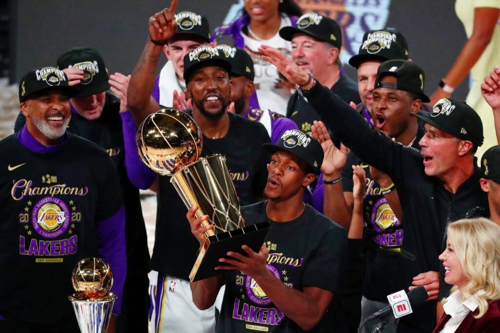 Oct 11, 2020; Lake Buena Vista, Florida, USA; Los Angeles Lakers guard Rajon Rondo (9) holds the trophy as he celebrates with teammates after game six of the 2020 NBA Finals at AdventHealth Arena. The Los Angeles Lakers won 106-93 to win the series. Mandatory Credit: Kim Klement-USA TODAY Sports