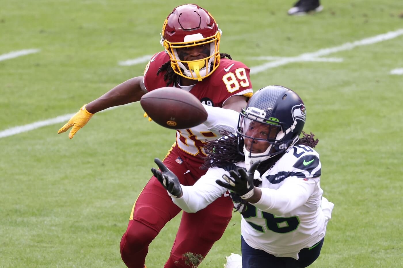 Dec 20, 2020; Landover, Maryland, USA; Seattle Seahawks cornerback Shaquill Griffin (26) intercepts a pass in front of Washington Football Team wide receiver Cam Sims (89) in the second quarter at FedExField. Mandatory Credit: Geoff Burke-USA TODAY Sports