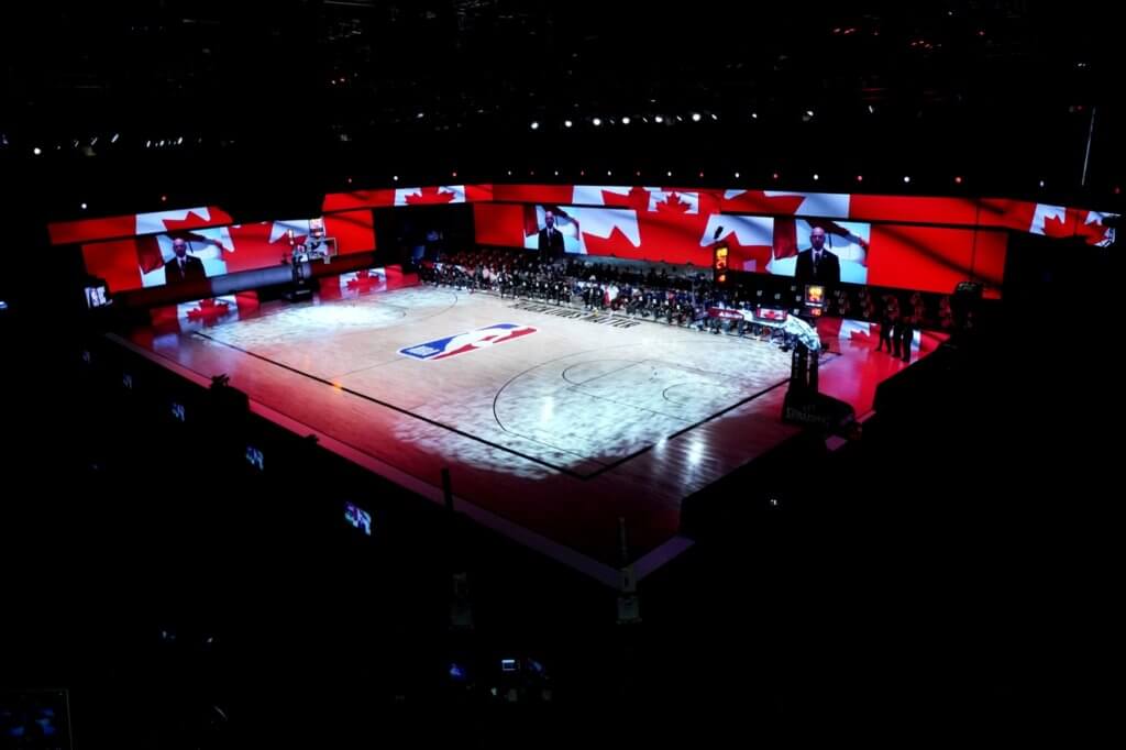 Aug 7, 2020; Lake Buena Vista, Florida, USA; The Canada flag is projected on the video boards during the playing of the Canadian national anthem prior to an NBA basketball game between the Boston Celtics and the Toronto Raptors at The Arena. Mandatory Credit: Ashley Landis/Pool Photo-USA TODAY Sports