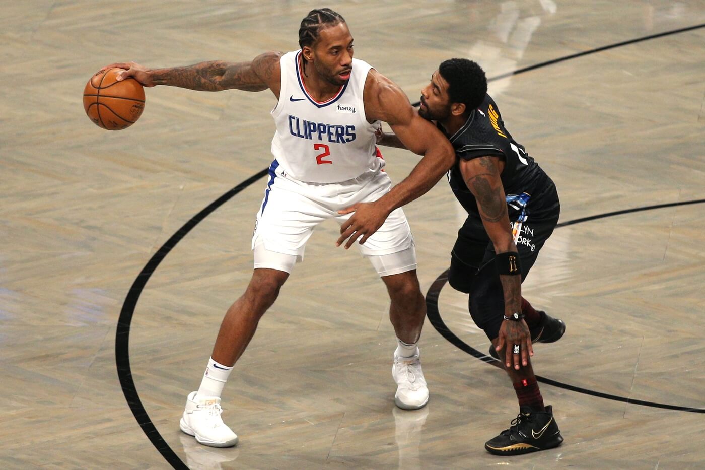Feb 2, 2021; Brooklyn, New York, USA; Los Angeles Clippers small forward Kawhi Leonard (2) controls the ball against Brooklyn Nets point guard Kyrie Irving (11) during the first quarter at Barclays Center. Mandatory Credit: Brad Penner-USA TODAY Sports