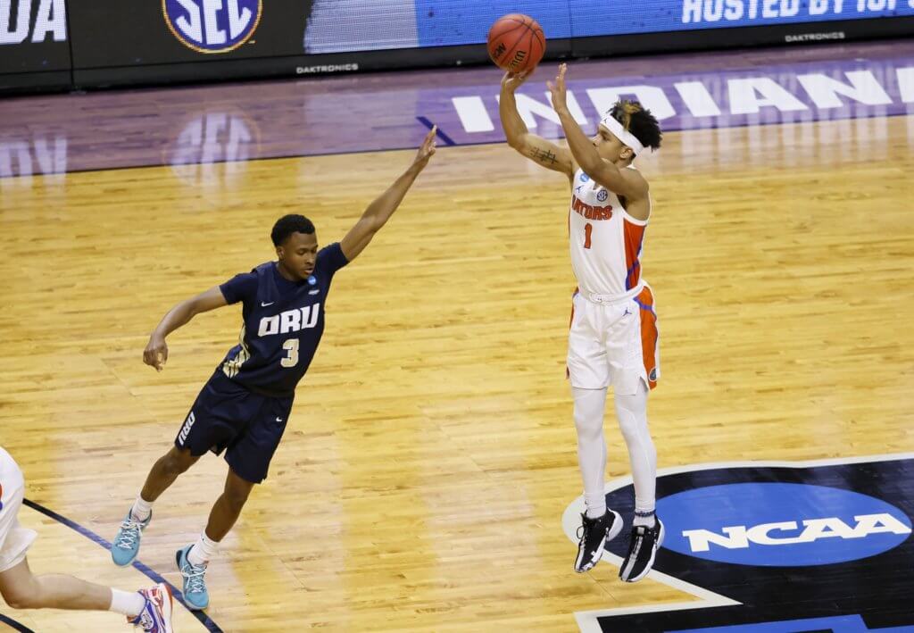 Florida Gators guard Tre Mann (1) shoots a jumper over Oral Roberts Golden Eagles guard Max Abmas (3) in the second half during the second round of the 2021 NCAA Tournament on Sunday, March 21, 2021, at Indiana Farmers Coliseum in Indianapolis, Ind