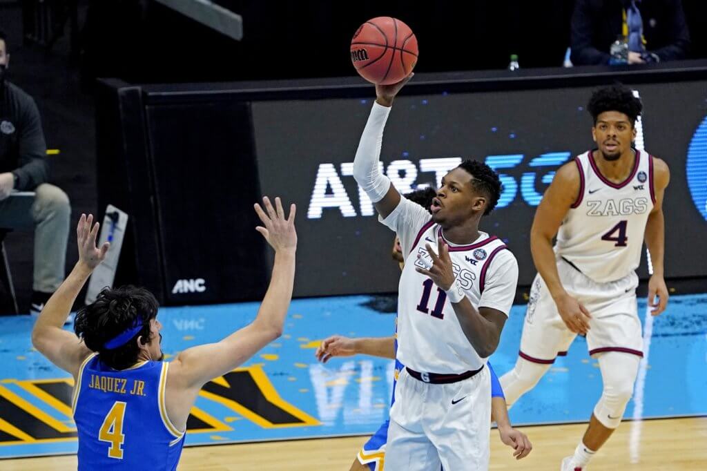 Gonzaga Bulldogs guard Joel Ayayi (11) shoots the ball against UCLA Bruins guard Jaime Jaquez Jr. (4) during the second half in the national semifinals of the Final Four of the 2021 NCAA Tournament at Lucas Oil Stadium. 