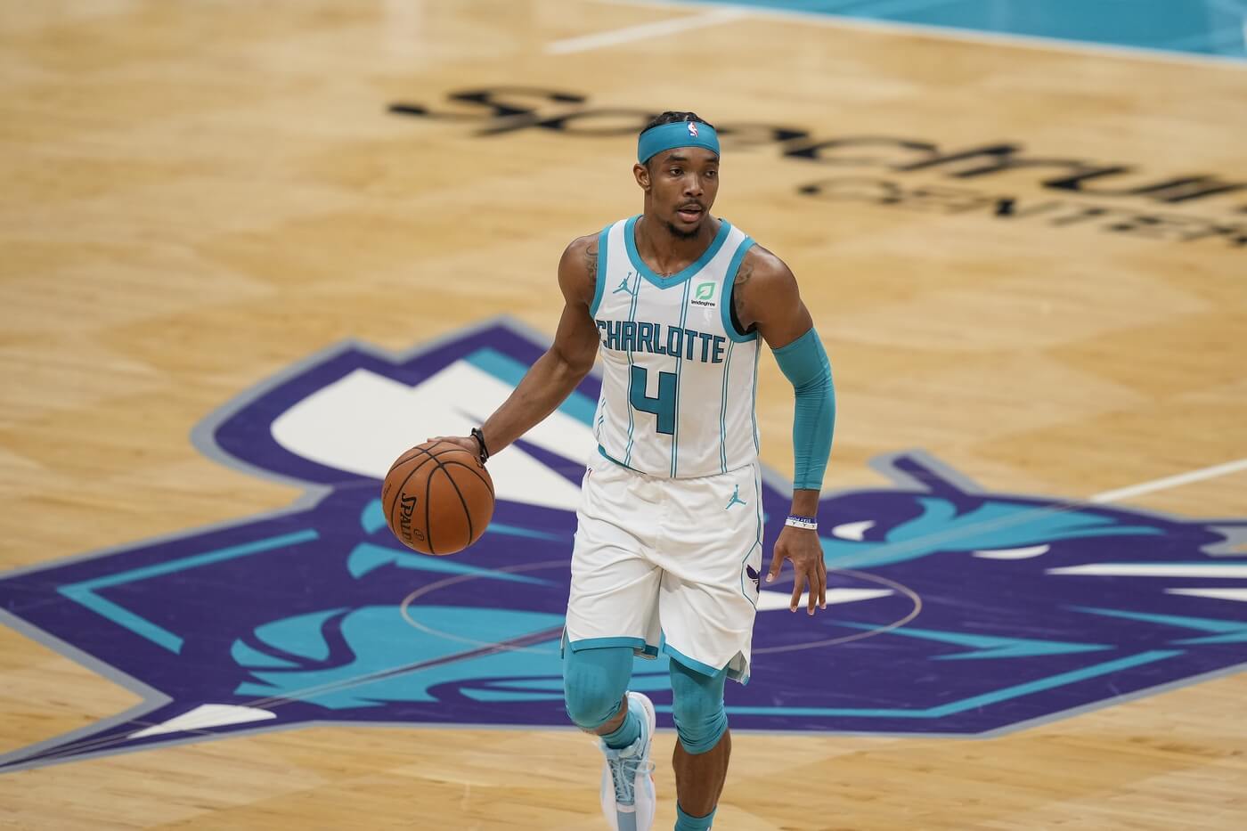 Apr 14, 2021; Charlotte, North Carolina, USA; Charlotte Hornets guard Devonte' Graham (4) handles the ball during the second half against the Cleveland Cavaliers at the Spectrum Center. Mandatory Credit: Jim Dedmon-USA TODAY Sports