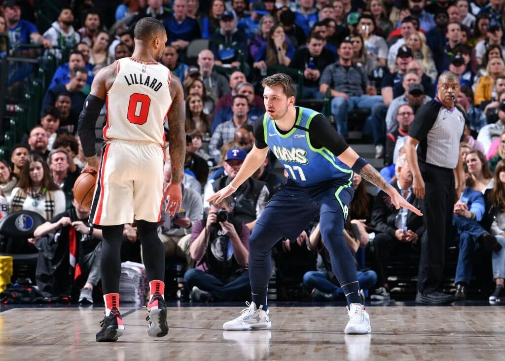 DALLAS, TX - JANUARY 17: Luka Doncic #77 of the Dallas Mavericks plays defense against Damian Lillard #0 of the Portland Trail Blazers on January 17, 2020 at the American Airlines Center in Dallas, Texas. NOTE TO USER: User expressly acknowledges and agrees that, by downloading and or using this photograph, User is consenting to the terms and conditions of the Getty Images License Agreement. Mandatory Copyright Notice: Copyright 2020 NBAE (Photo by Glenn James/NBAE via Getty Images)