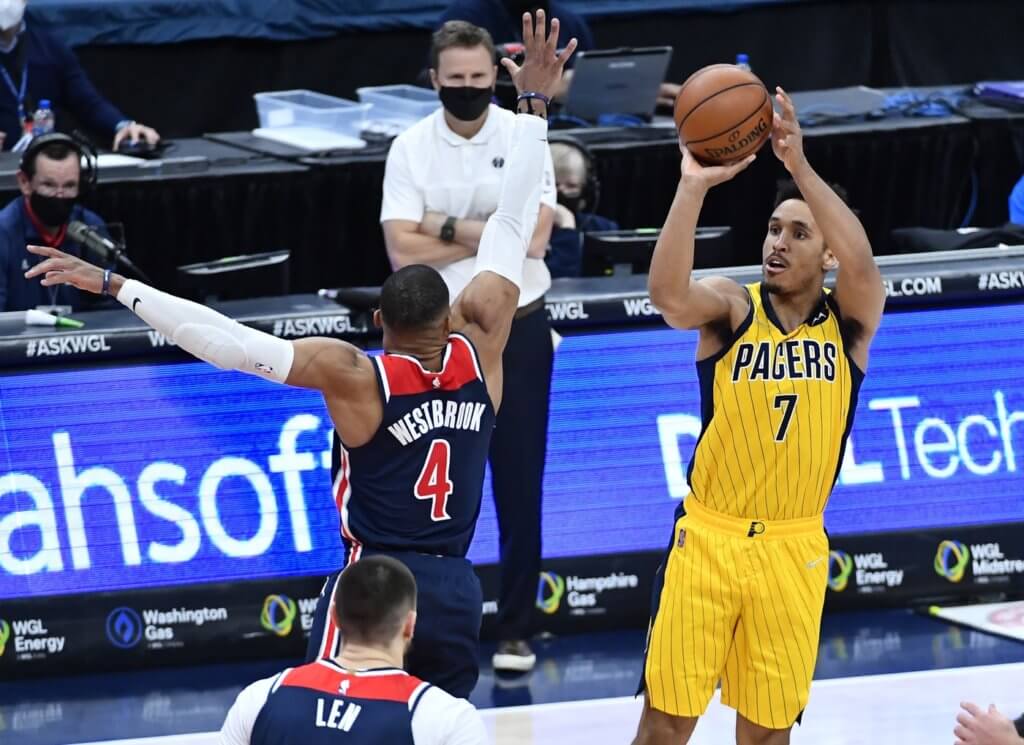 Mar 29, 2021; Washington, District of Columbia, USA; Indiana Pacers guard Malcolm Brogdon (7) shoots the ball over Washington Wizards guard Russell Westbrook (4) during the fourth quarter at Capital One Arena. Mandatory Credit: Brad Mills-USA TODAY Sports