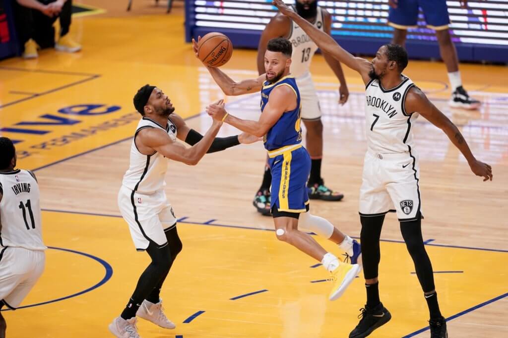 Feb 13, 2021; San Francisco, California, USA; Golden State Warriors guard Stephen Curry (30) passes the ball away from the reach of Brooklyn Nets forward Kevin Durant (7) in the first quarter at the Chase Center. Mandatory Credit: Cary Edmondson-USA TODAY Sports