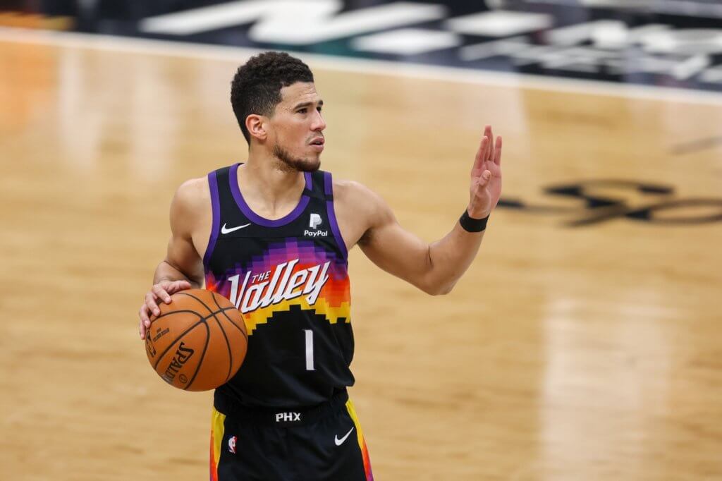 Mar 28, 2021; Charlotte, North Carolina, USA; Phoenix Suns guard Devin Booker (1) against the Charlotte Hornets during the second half at Spectrum Center. The Phoenix Suns won 101-97 in overtime. Mandatory Credit: Nell Redmond-USA TODAY Sports