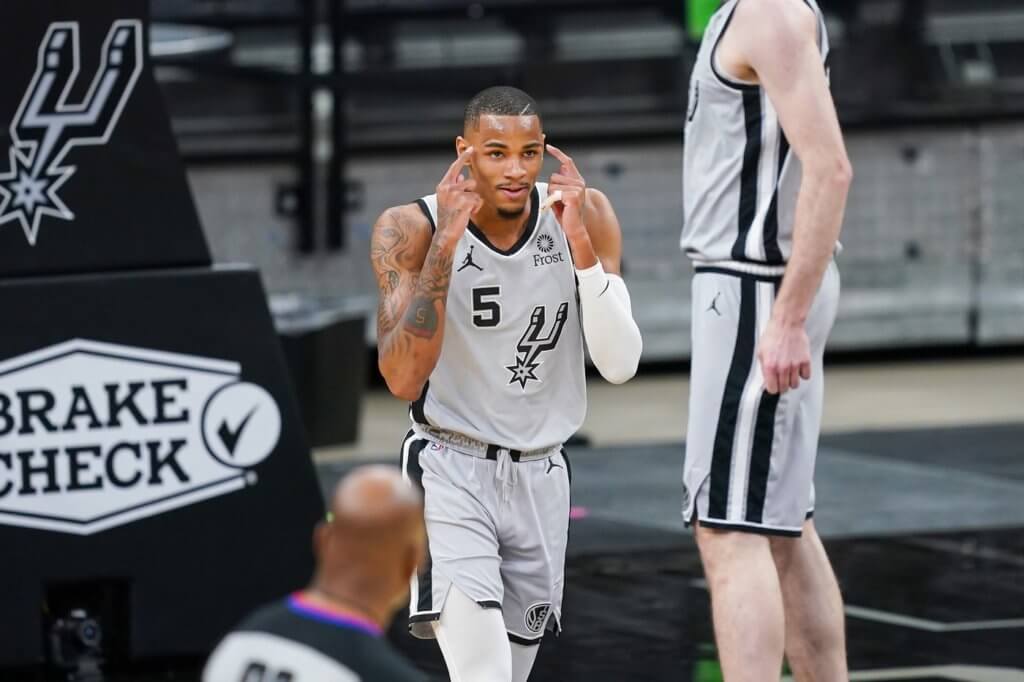 Mar 29, 2021; San Antonio, Texas, USA; San Antonio Spurs guard Dejounte Murray (5) reacts in the first half against the Sacramento Kings at the AT&T Center. Mandatory Credit: Daniel Dunn-USA TODAY Sports

