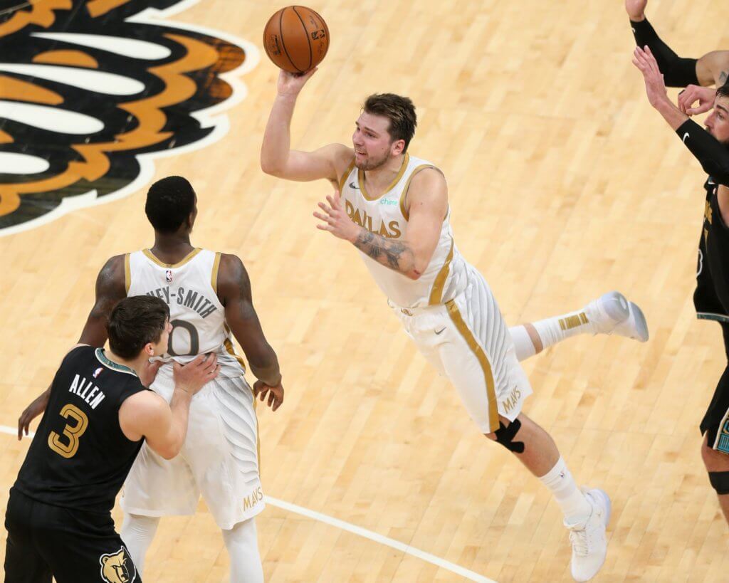 Apr 14, 2021; Memphis, Tennessee, USA; Dallas Mavericks guard Luka Doncic (77) shoots a three-point basket against the Memphis Grizzlies as time expired in the fourth quarter at FedExForum. Mandatory Credit: Nelson Chenault-USA TODAY Sports