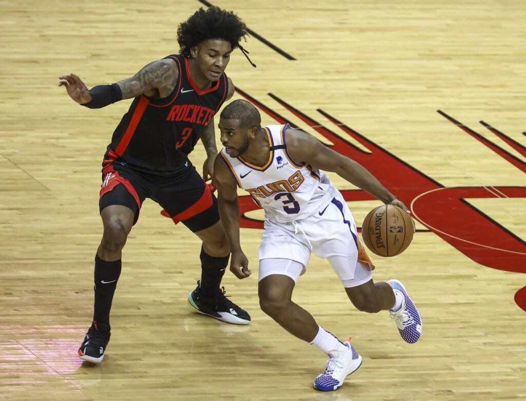 Apr 5, 2021; Houston, Texas, USA; Positive Record Phoenix Suns guard Chris Paul (right) dribbles the ball against Houston Rockets guard Kevin Porter Jr. (left) during the third quarter at Toyota Center. Mandatory Credit: Troy Taormina-USA TODAY Sports