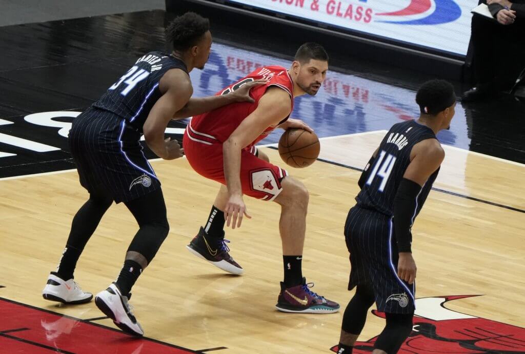 Apr 14, 2021; Chicago, Illinois, USA; Chicago Bulls center Nikola Vucevic (9) dribbles the ball while defended by Orlando Magic center Wendell Carter Jr. (34) during the first quarter at the United Center. Mandatory Credit: Mike Dinovo-USA TODAY Sports