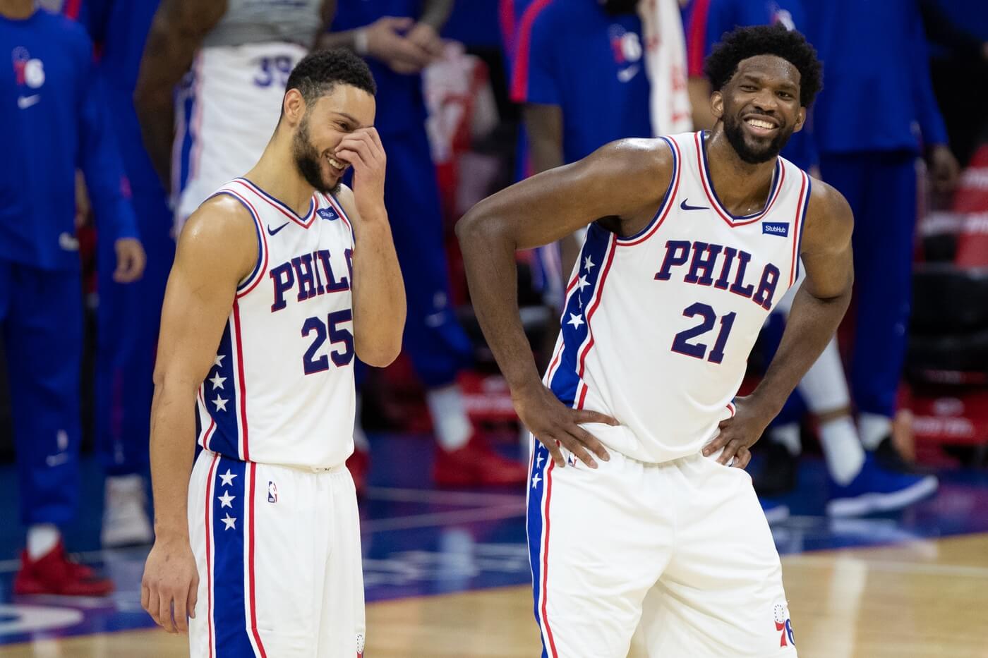 Jan 6, 2021; Philadelphia, Pennsylvania, USA; Philadelphia 76ers center Joel Embiid (21) and guard Ben Simmons (25) react in the closing seconds of the fourth quarter against the Washington Wizards at Wells Fargo Center. Mandatory Credit: Bill Streicher-USA TODAY Sports