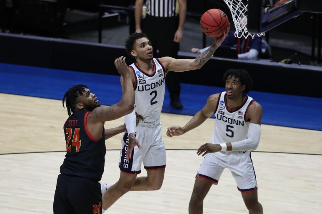 Mar 20, 2021; West Lafayette, Indiana, USA; Connecticut Huskies guard James Bouknight (2) shoots the ball over Maryland Terrapins forward Donta Scott (24) as Connecticut forward Isaiah Whaley (5) looks on during the second half in the first round of the 2021 NCAA Tournament at Mackey Arena. Mandatory Credit: Joshua Bickel-USA TODAY Sports